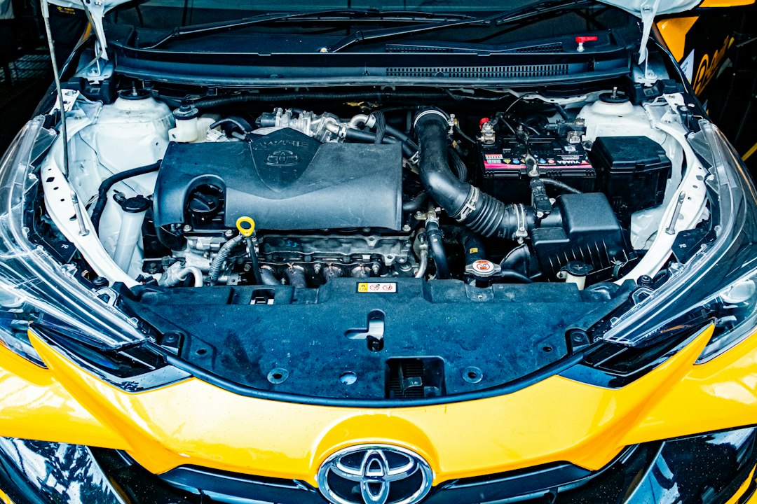 Ruang mesin mobil terbuka dengan aki dan tabung cairan terlihat dari atas