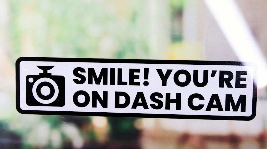 Stiker bertuliskan slogan dash cam yang ditempel di kaca kendaraan